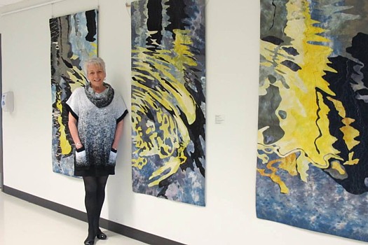 Fiber Artist Barbara Schneider and her artwork. Photo credit, Barbara Schneider Textile Artist Facebook Page